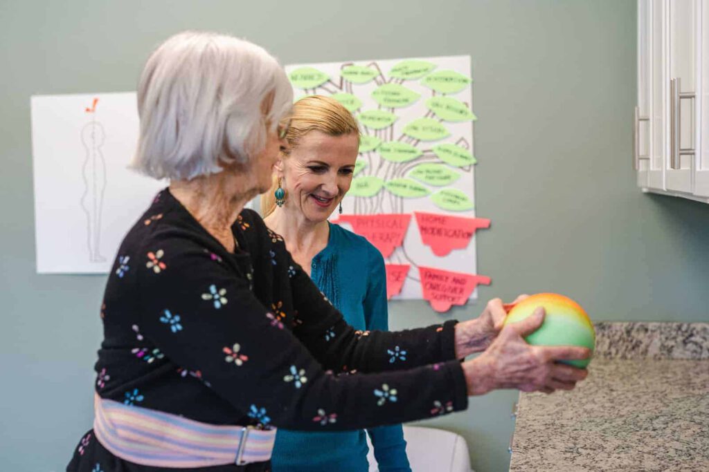 Senior woman and staff member during a physical therapy exercise - The Colonnade at Northdale